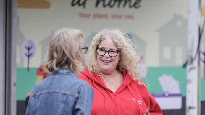 A thirteen colleague speaking to a customer outside the mobile van