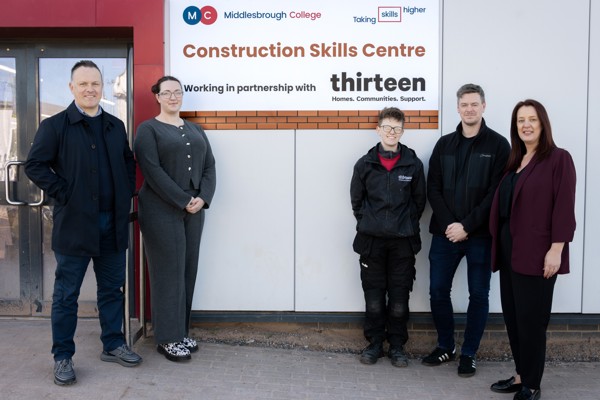 Colleagues from Middlesbrough College and Thirteen Group stood in front of the new construction skills centre sign