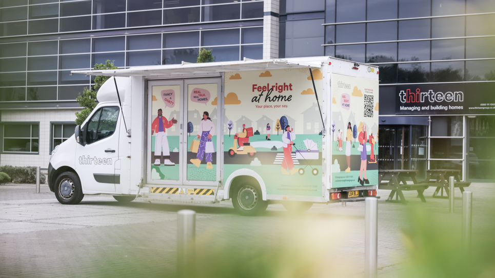 The mobile touchpoint van in front of an office building