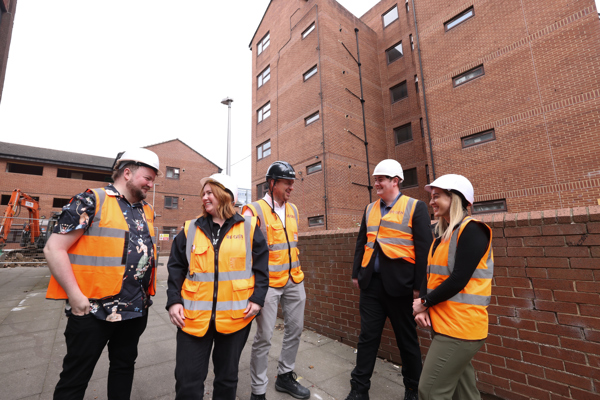 A customer stood outside with representatives from Thirteen and RE:GEN at Central Mews, Middlesbrough