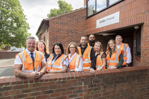 Thirteen and Equans representatives standing in front of Cedar House in Stockton