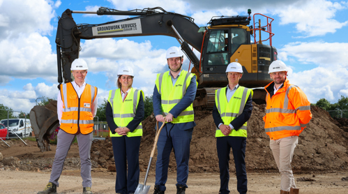 Representatives from Thirteen, RE:GEN and the Middlesbrough Mayor standing on site at the new Fleet and Thorntree development with a digger in the background