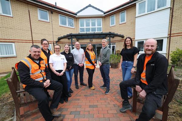 Contractors and colleagues standing outside of Bellamy Court in Middlesbrough