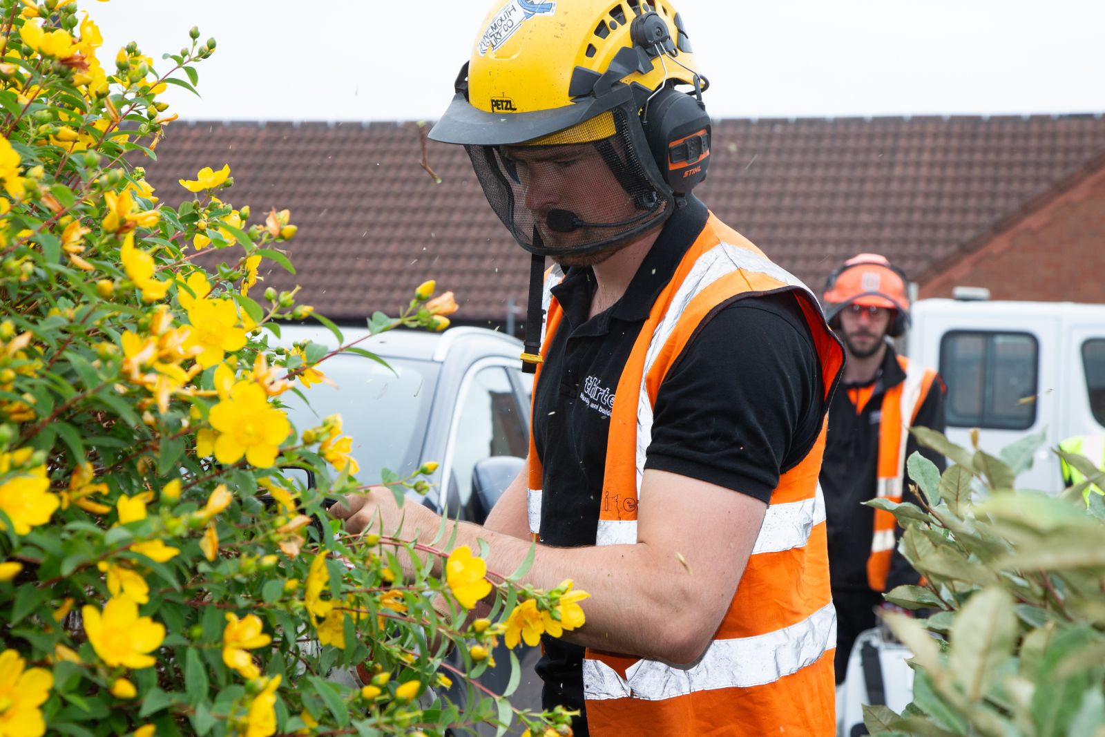 Man cutting back shrubs as part of a garden makeover for a customer in Hull.