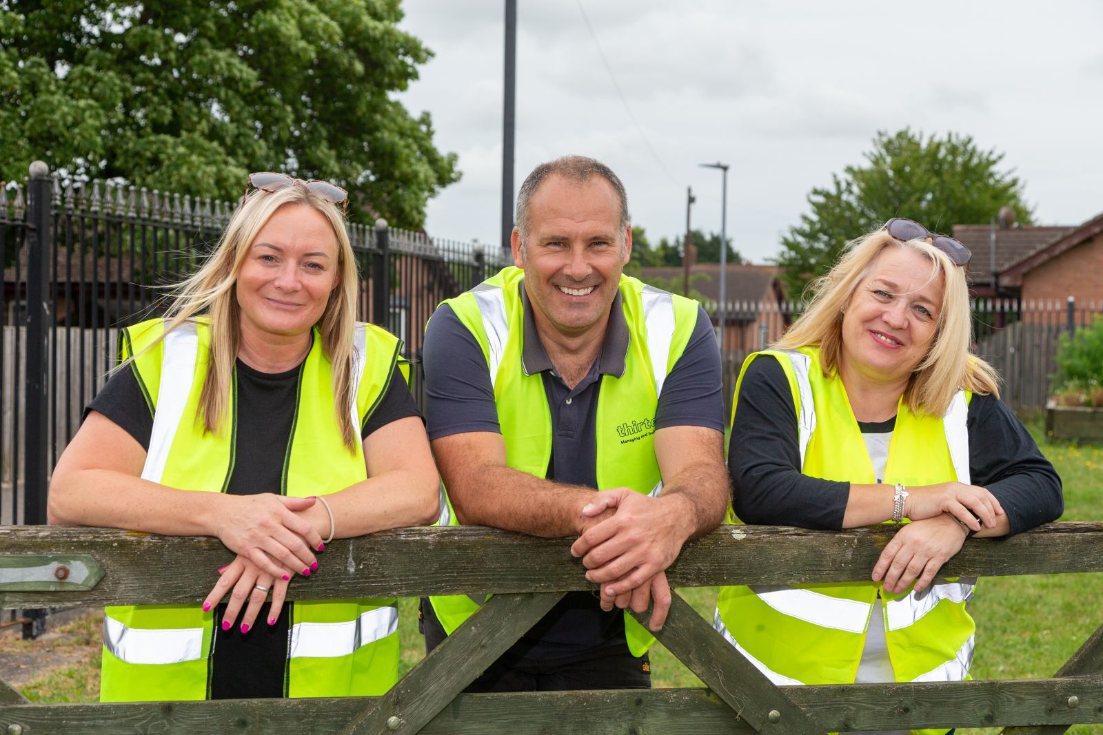 Jane Hobbs, Duane Newton and Cheryl Hodds from Thirteen's community resilience team smiling as they take part in a day of action.