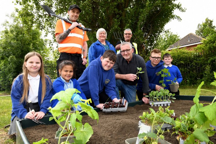 Group of school children with plants 