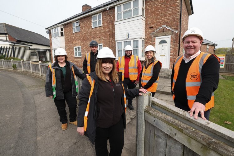 team members on a housing estate wearing hi vis clothing