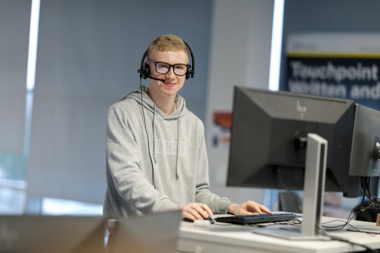 Thirteen staff member speaking to a customer on the phone