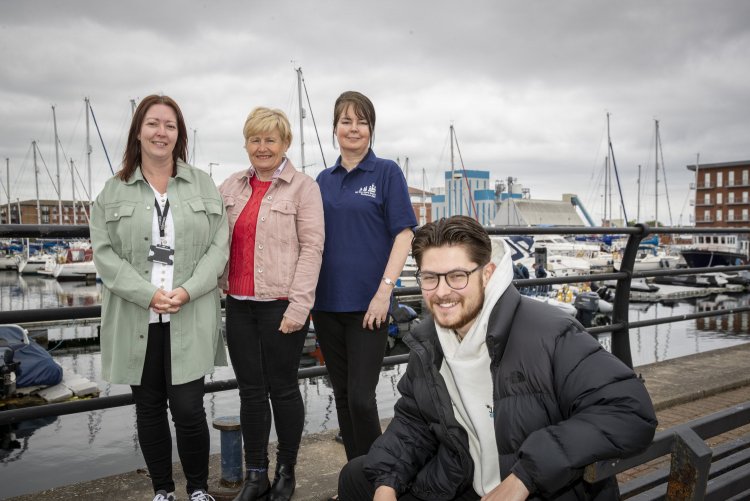 A photo of Thirteen's sponsored sail trainee Rhyse Horton alongside members of the community resilience team and the Tall Ships team at Hartlepool Marina